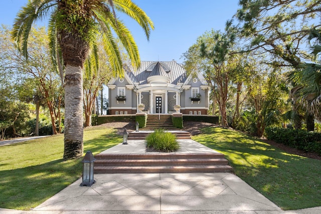 view of front of house featuring french doors and a front lawn