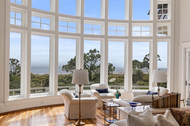 sunroom / solarium featuring a water view and a wealth of natural light