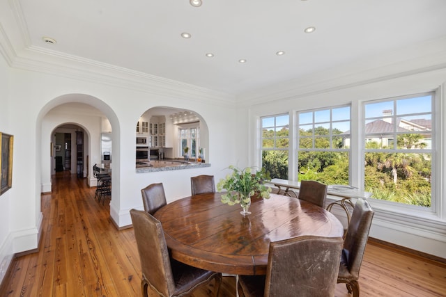 dining room featuring ornamental molding and light hardwood / wood-style flooring