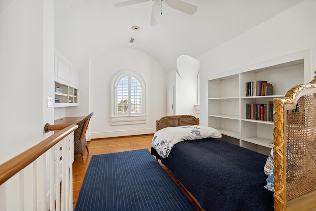 bedroom featuring light hardwood / wood-style floors, lofted ceiling, and ceiling fan