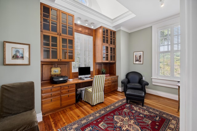 office space with ornamental molding, light hardwood / wood-style flooring, and a healthy amount of sunlight