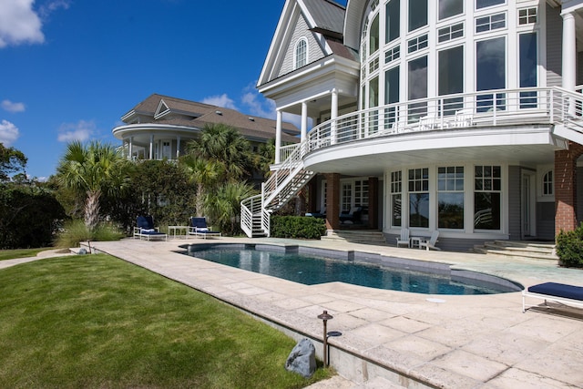 view of pool featuring a patio and a lawn