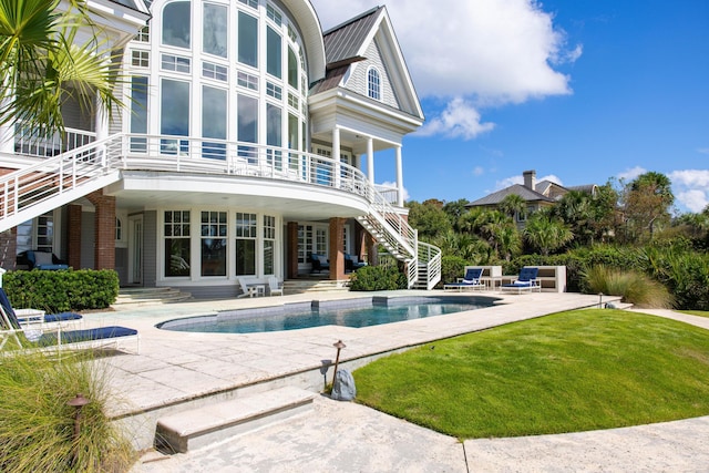 view of pool with a yard and a patio area