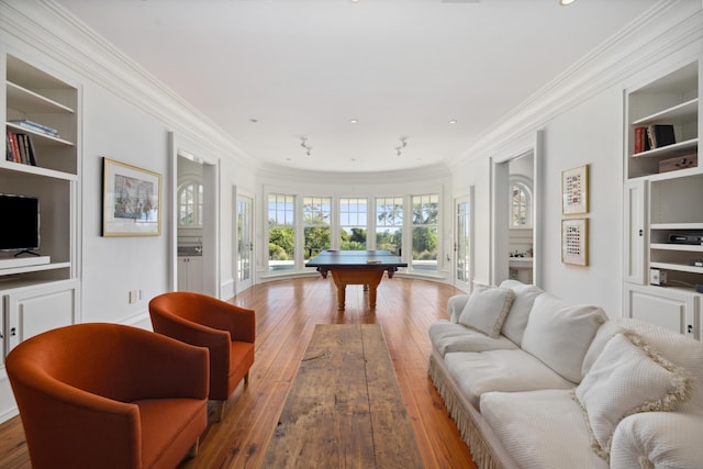 recreation room featuring pool table, crown molding, wood-type flooring, and built in features