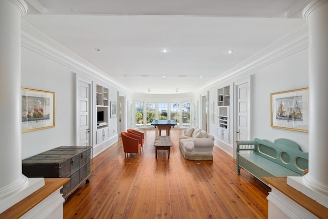 living room with ornate columns, hardwood / wood-style flooring, and ornamental molding