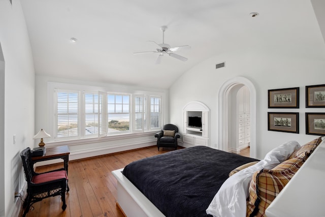 bedroom featuring ceiling fan, lofted ceiling, and light hardwood / wood-style flooring