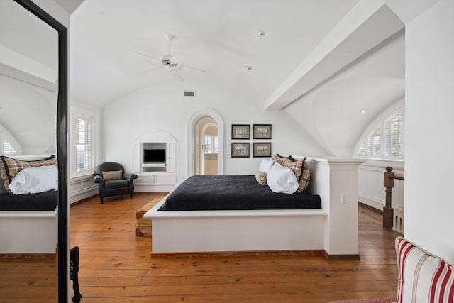 bedroom featuring ceiling fan, hardwood / wood-style flooring, and vaulted ceiling