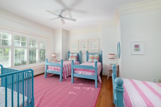 bedroom with ornamental molding, hardwood / wood-style floors, and ceiling fan