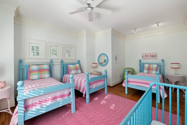 bedroom featuring crown molding, wood-type flooring, and ceiling fan