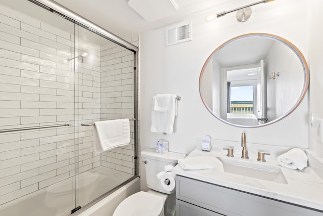 full bathroom with toilet, vanity, and combined bath / shower with glass door