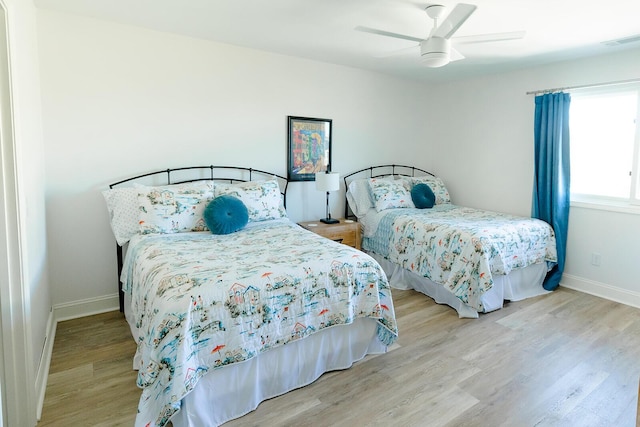 bedroom with ceiling fan and light wood-type flooring