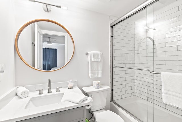 full bathroom with vanity, combined bath / shower with glass door, and toilet