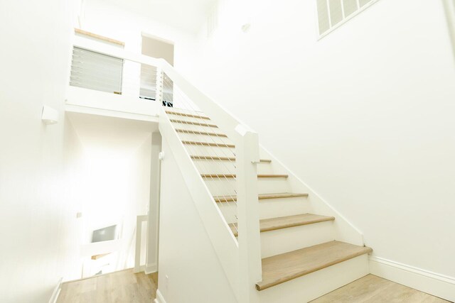 stairs featuring hardwood / wood-style floors