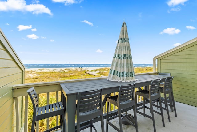 exterior space featuring a water view and a view of the beach