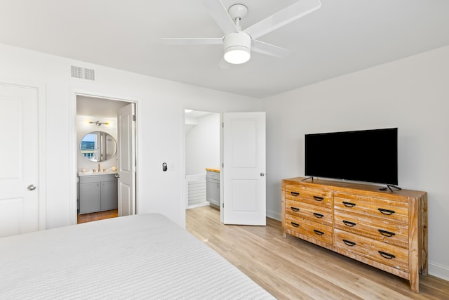 bedroom featuring connected bathroom, ceiling fan, and wood-type flooring