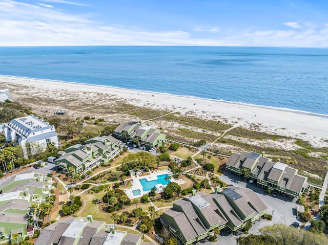 birds eye view of property with a water view and a view of the beach