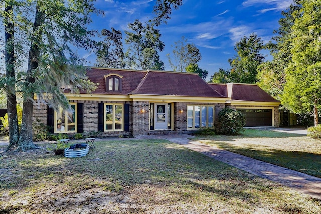 428 Carn St, Walterboro, SC 29488 - view of front facade with a front lawn, a garage, and brick siding