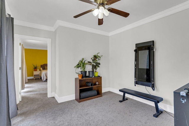 workout room with crown molding, light carpet, and ceiling fan