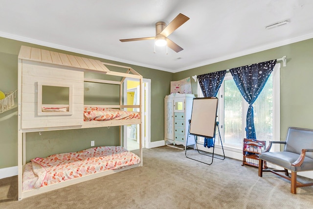 bedroom with ceiling fan, crown molding, and carpet flooring