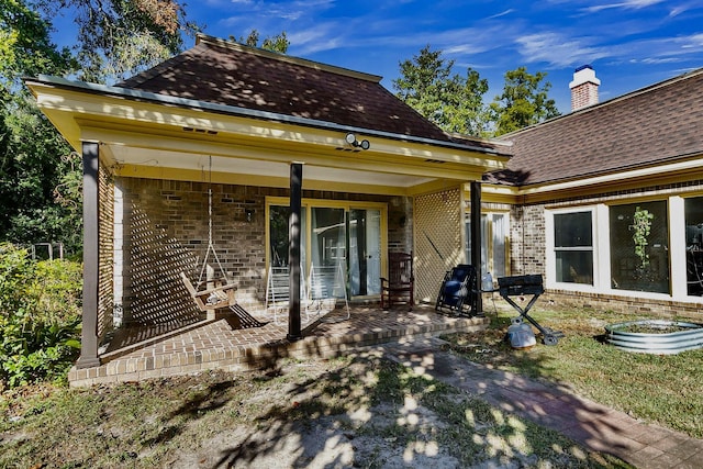 428 Carn St, Walterboro, SC 29488 - back of property with a patio area, a shingled roof, and brick siding
