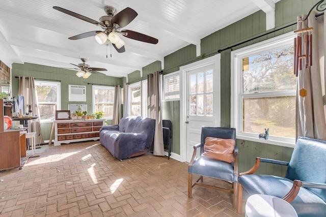 sunroom / solarium with beamed ceiling and ceiling fan