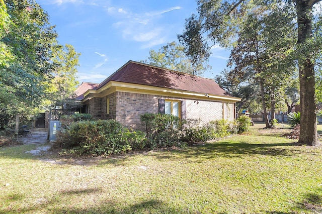 view of property exterior with a lawn