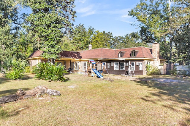 rear view of property featuring a yard