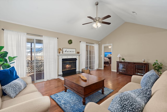 living room with ceiling fan, lofted ceiling, and wood-type flooring