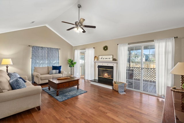 living room with vaulted ceiling, hardwood / wood-style floors, and ceiling fan