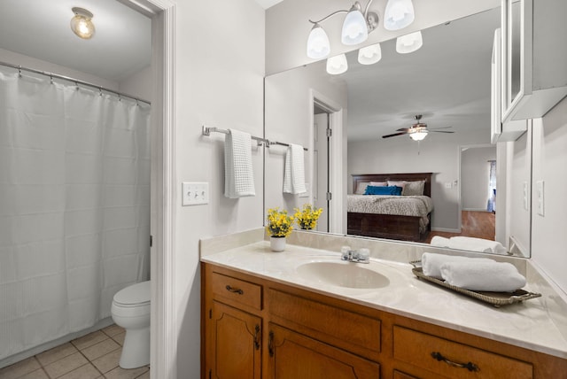 bathroom with vanity, ceiling fan, tile patterned floors, and toilet