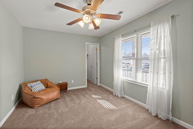 unfurnished room with ceiling fan and light carpet