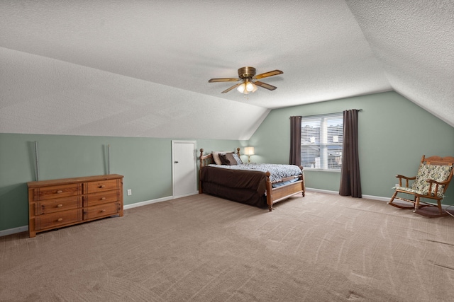 carpeted bedroom with ceiling fan, lofted ceiling, and a textured ceiling