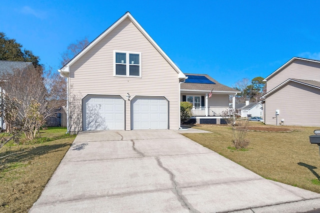 view of property featuring a porch, a garage, and a front yard