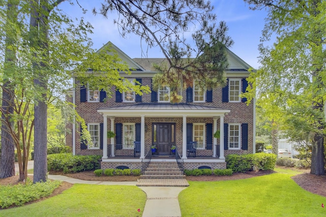 750 Navigators Run, Mount Pleasant, SC 29464 - colonial home with brick siding, covered porch, a front yard, and a standing seam roof