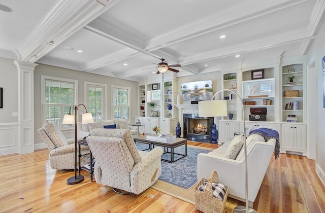 750 Navigators Run, Mount Pleasant, SC 29464 - living area with light wood-style flooring, built in shelves, beamed ceiling, crown molding, and a lit fireplace