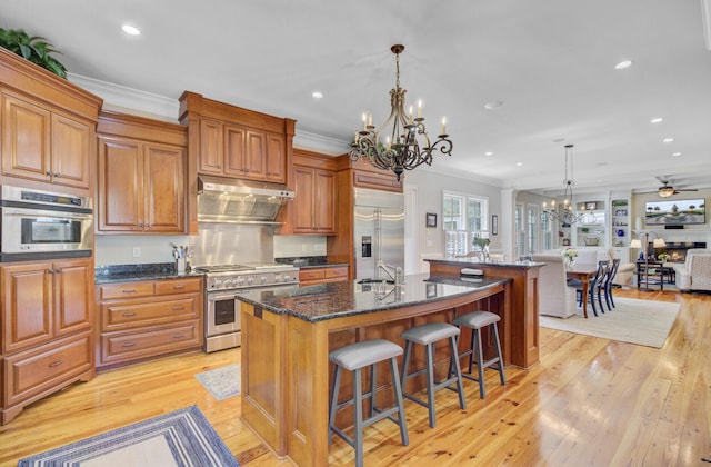750 Navigators Run, Mount Pleasant, SC 29464 - kitchen with premium appliances, a chandelier, a large island with sink, open floor plan, and crown molding