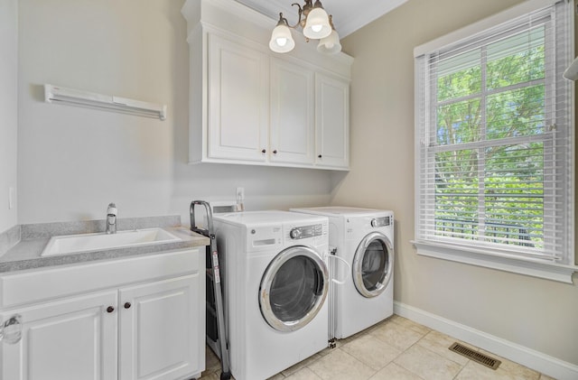 750 Navigators Run, Mount Pleasant, SC 29464 - laundry area with cabinet space, separate washer and dryer, healthy amount of natural light, and light tile patterned flooring
