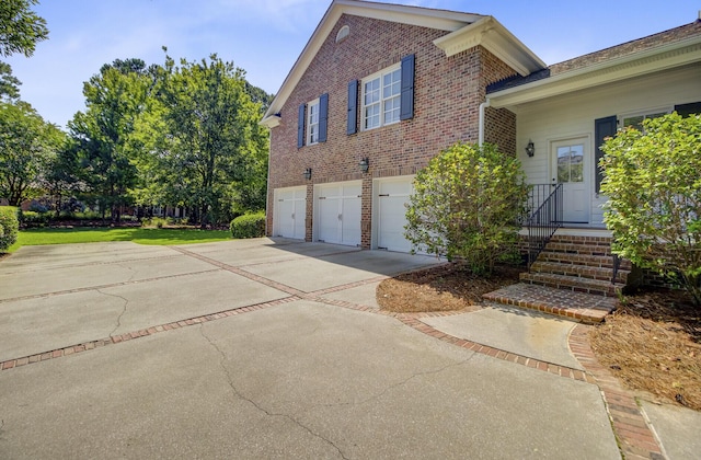 750 Navigators Run, Mount Pleasant, SC 29464 - view of side of property featuring concrete driveway, brick siding, and a garage