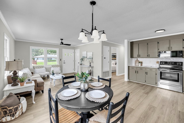 209 Pineview Dr, Goose Creek, SC 29445 - dining room featuring ornamental molding, light wood-style flooring, a chandelier, a ceiling fan, and baseboards