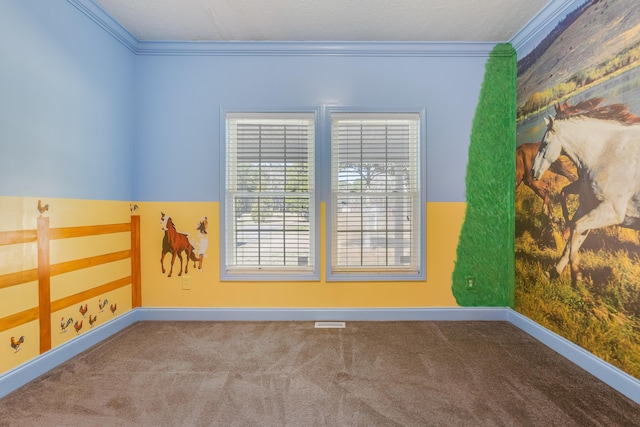 spare room featuring carpet floors, baseboards, visible vents, and ornamental molding