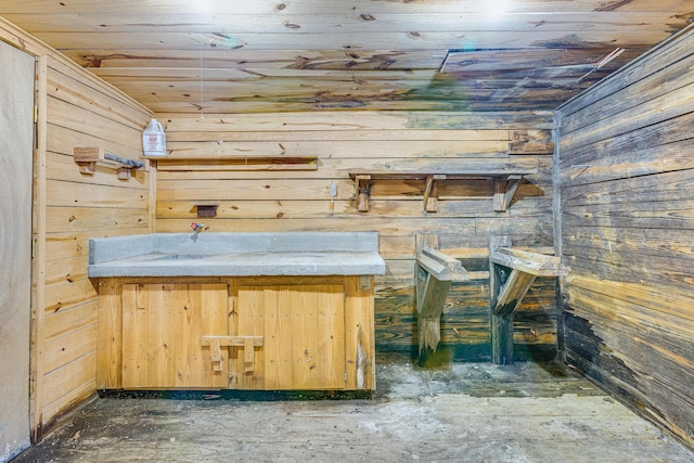 interior space featuring wood ceiling and wood walls