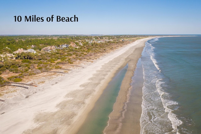 birds eye view of property featuring a beach view and a water view