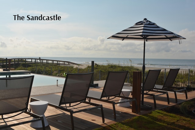 view of patio with a beach view and a water view