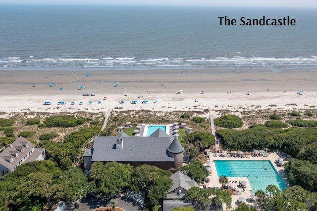 bird's eye view featuring a water view and a beach view