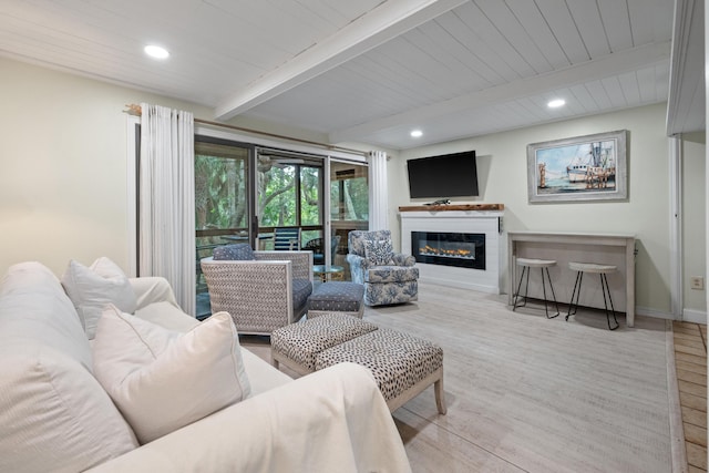 living room featuring beamed ceiling and light hardwood / wood-style flooring