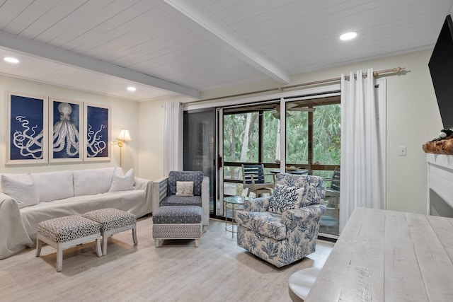 living room featuring beamed ceiling and light hardwood / wood-style flooring