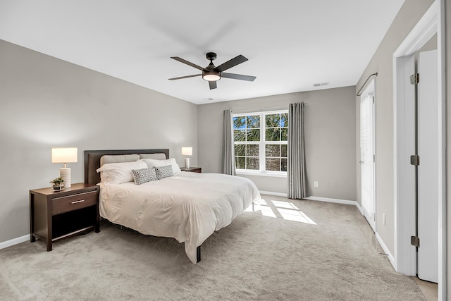 bedroom featuring baseboards, light carpet, visible vents, and a ceiling fan