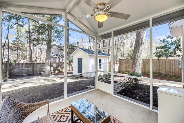 sunroom with a ceiling fan and lofted ceiling