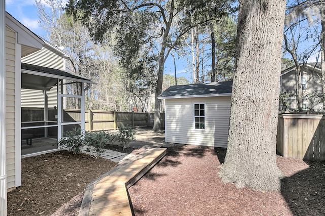 view of yard featuring a sunroom and fence