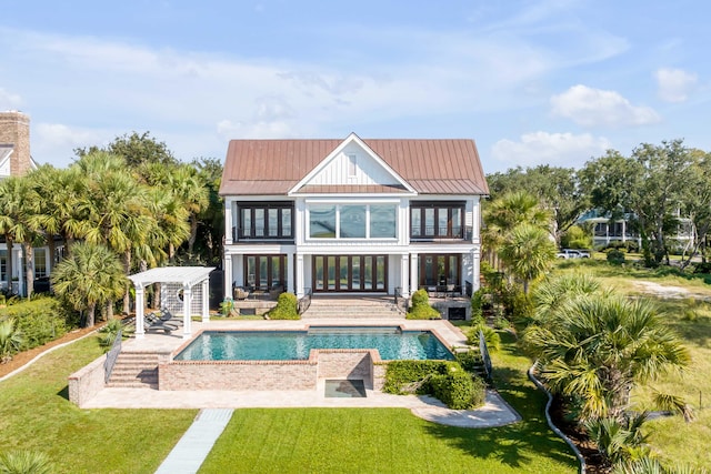 back of house with a patio, a pergola, and a lawn